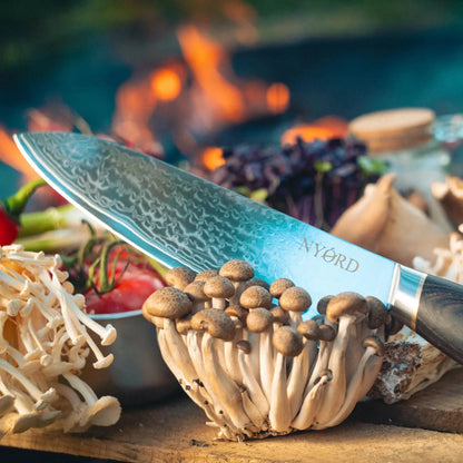 Damast Chefmesser schneidet durch Pilze